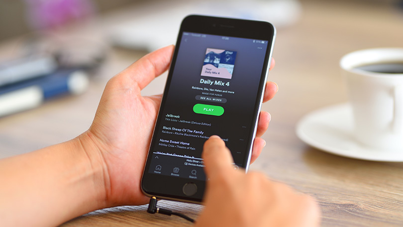 will downloading music on the spotify app download them on your phone